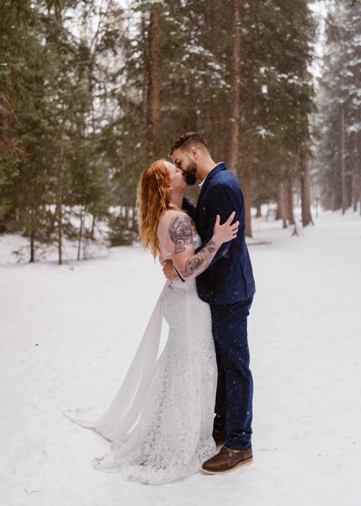 Couple kisses in the snow in Breckenridge, Colorado