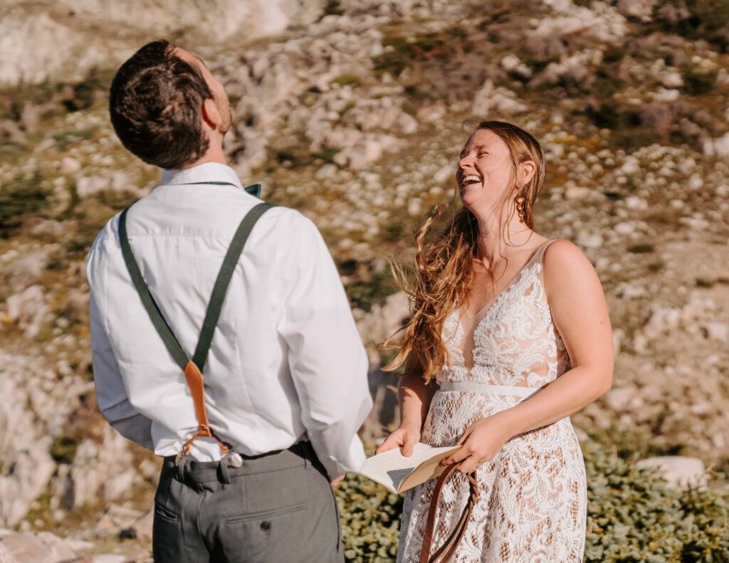 Couple laughs during their vow exchange at their camping elopement in Wyoming
