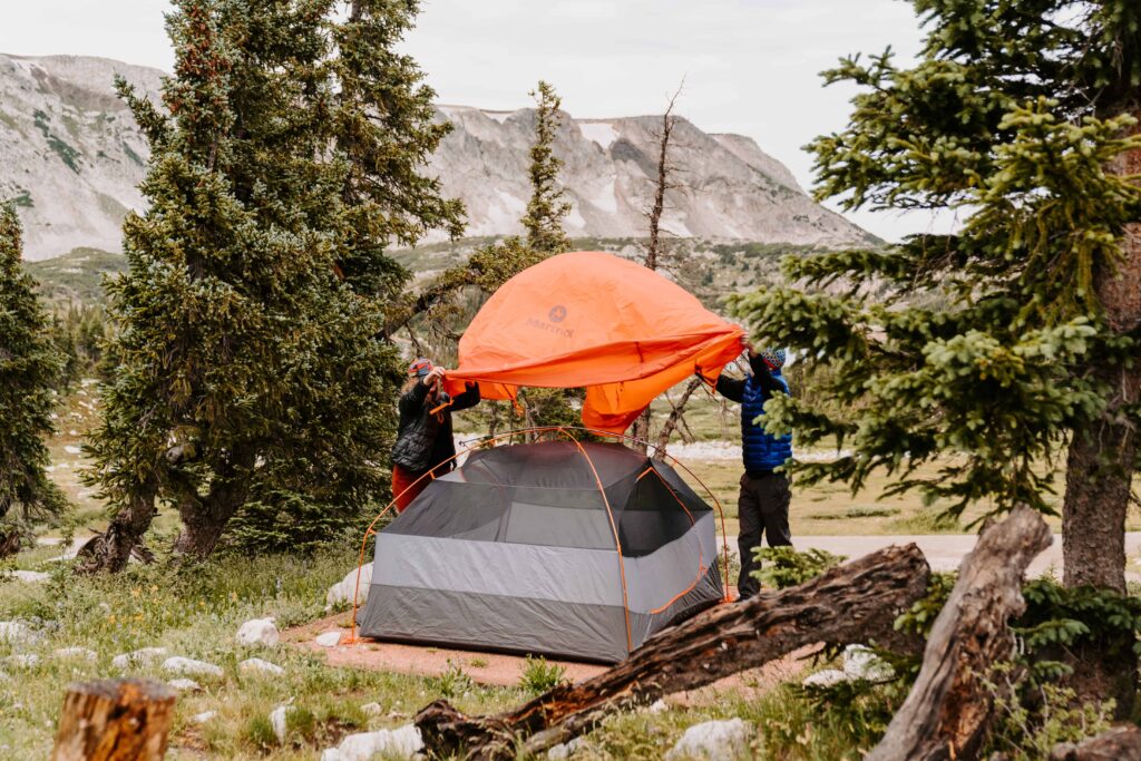 Couple sets up a tent together 