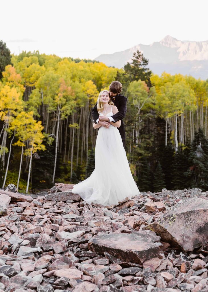 Couple stands in an Aspen grove during their Telluride Jeeping elopement