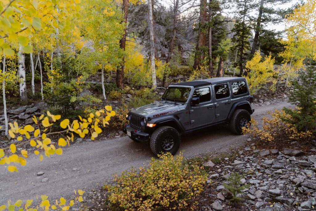 Couple jeeps through the San Juan Mountains in Colorado during their Telluride Jeeping elopement