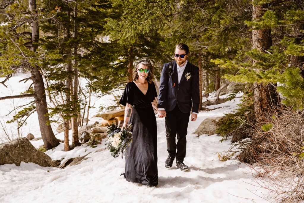 Couple hikes during their elopement at Bear Lake in Rocky Mountain National Park