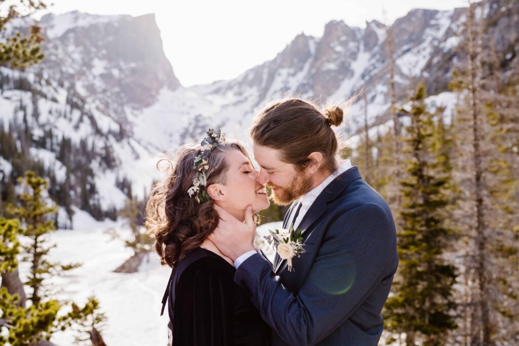 Bride and groom have portraits at Emerald Lake in Rocky Mountain National Park