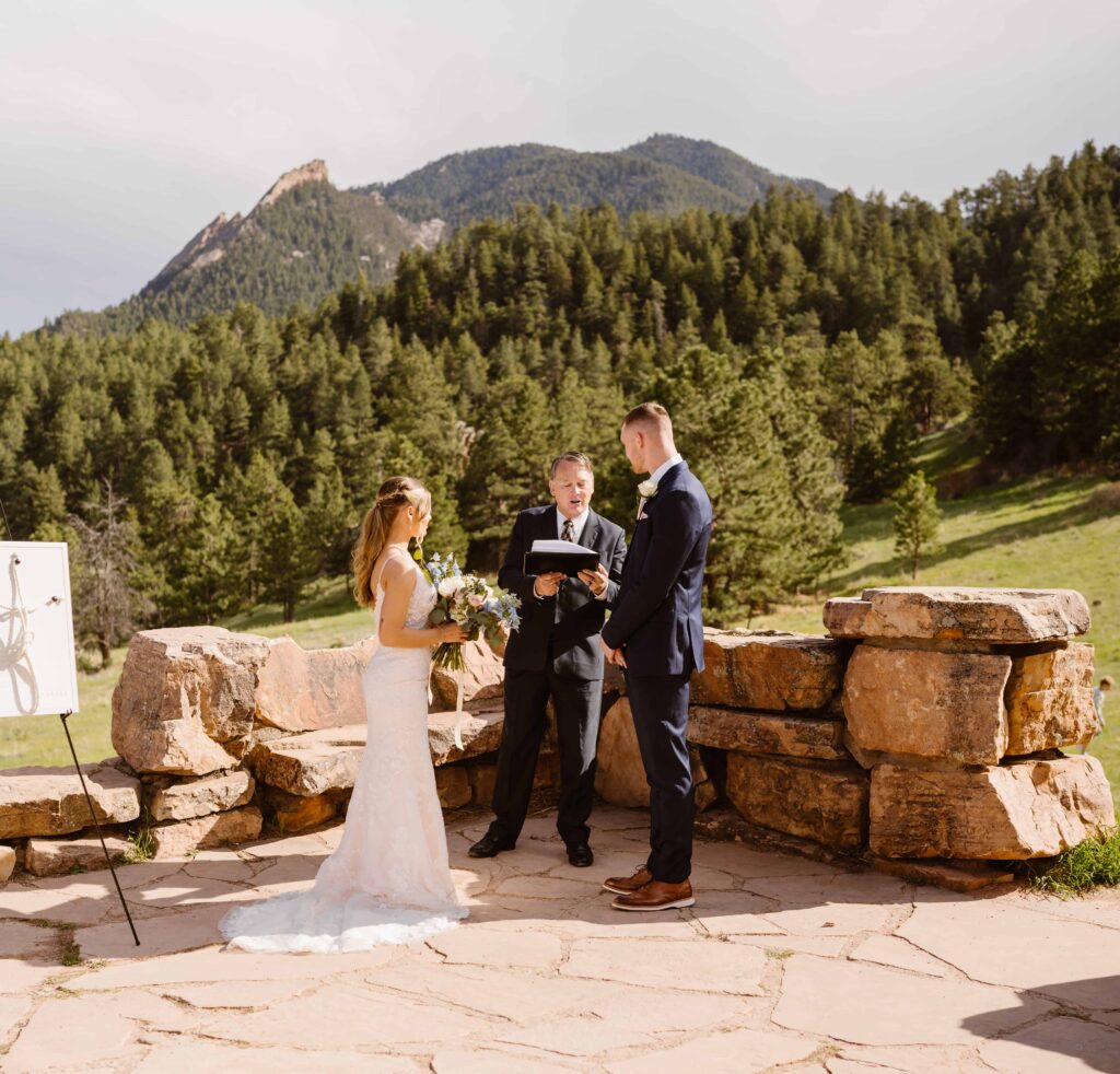 Officiant leads a ceremony during a mountain wedding in Boulder, Colorado