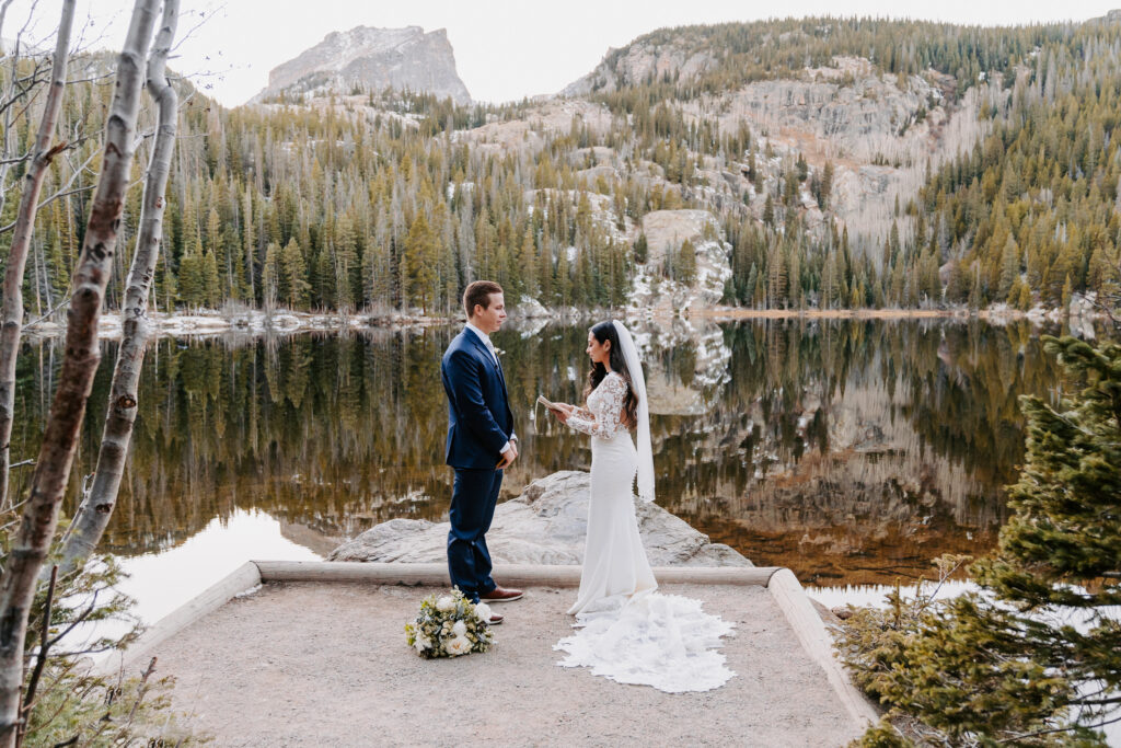 Couple elopes at Bear Lake in Rocky Mountain National Park, Colorado in the wintertime 