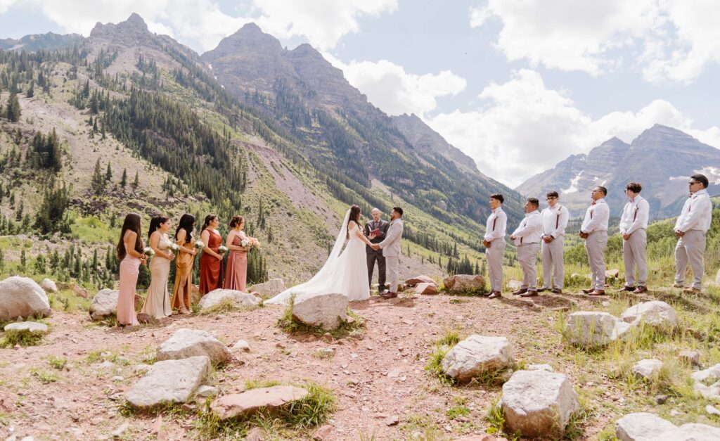 Couple has an intimate wedding with their bridesmaids and groomsmen at the Maroon Bells Amphitheater in Aspen, Colorado