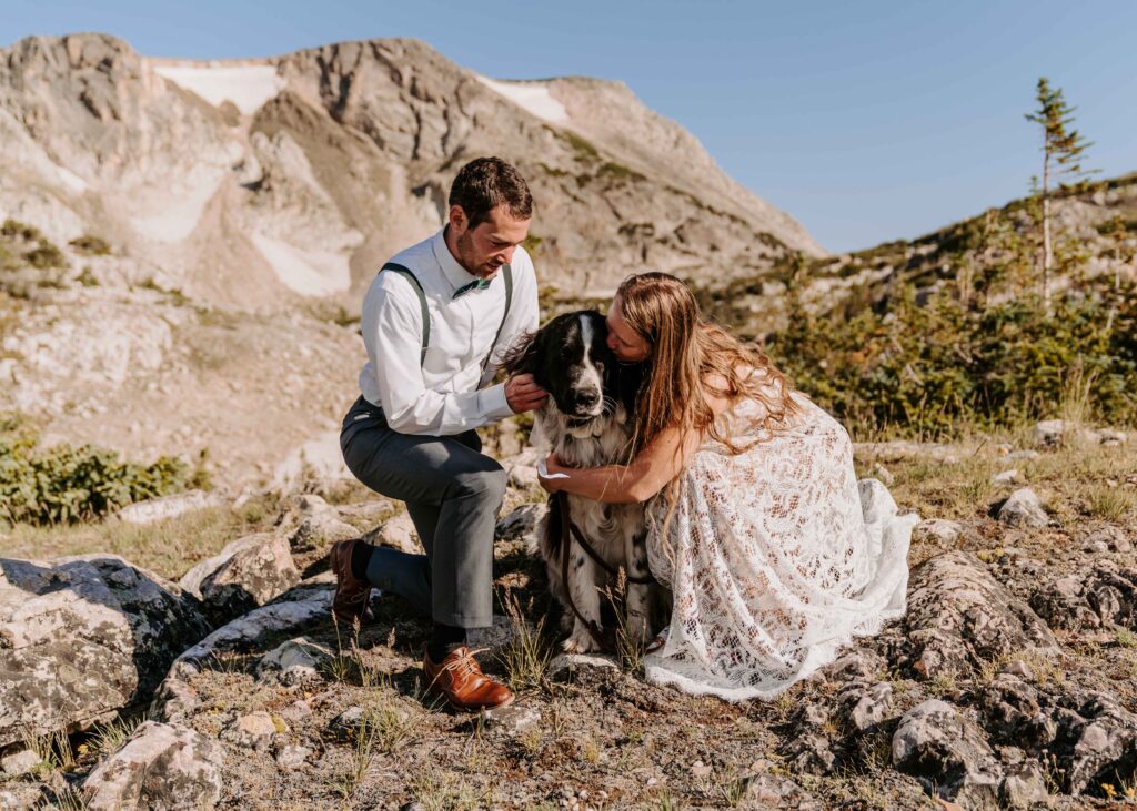 Couple kisses their dog during their Wyoming elopement