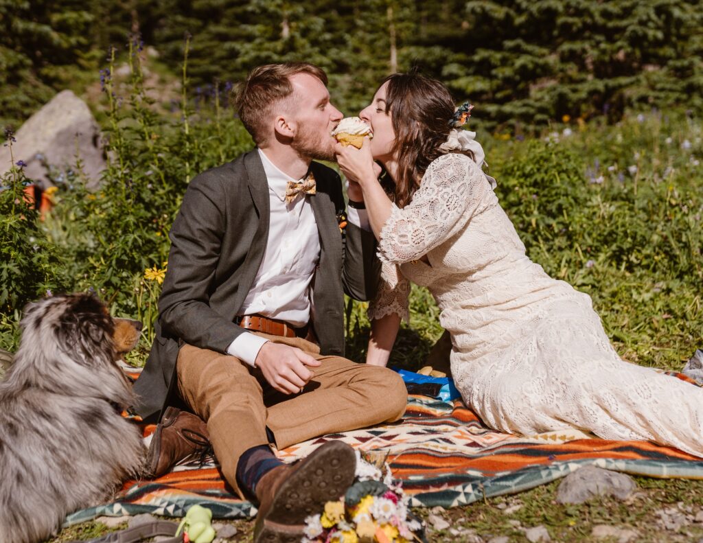 Couple eats a cupcake during their elopement in Colorado