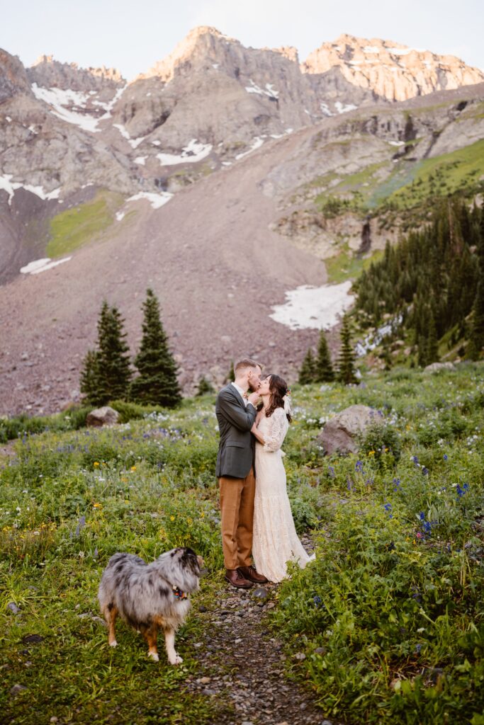 Couple takes wedding pictures at an alpine lake in Telluride, Colorado