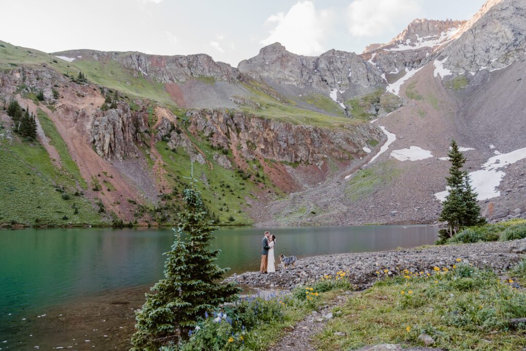 Couple takes wedding pictures at an alpine lake in Telluride, Colorado