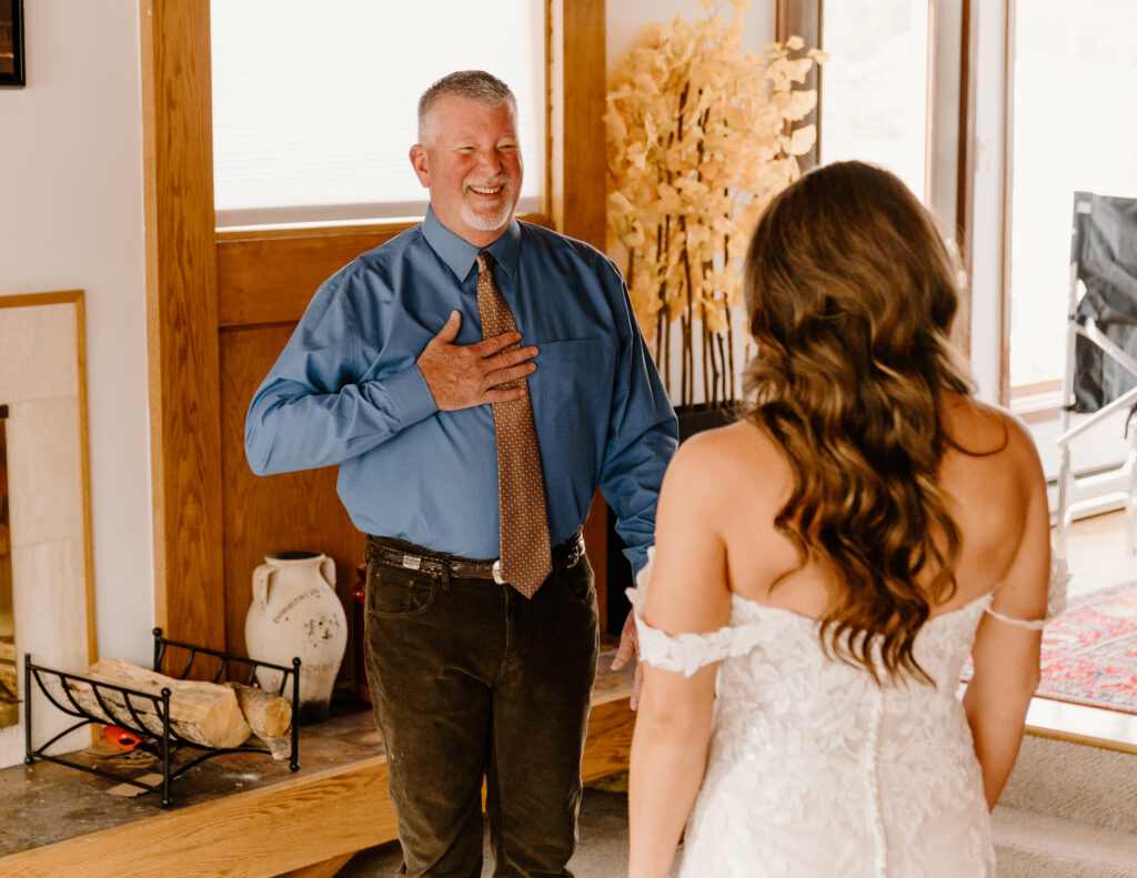 Bride has a first look with her dad before her winter elopement in Breckenridge, Colorado