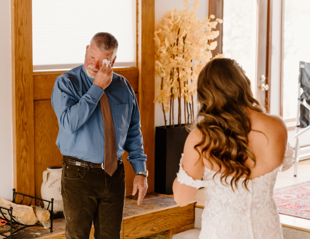 Bride has a first look with her dad before her winter elopement in Breckenridge, Colorado