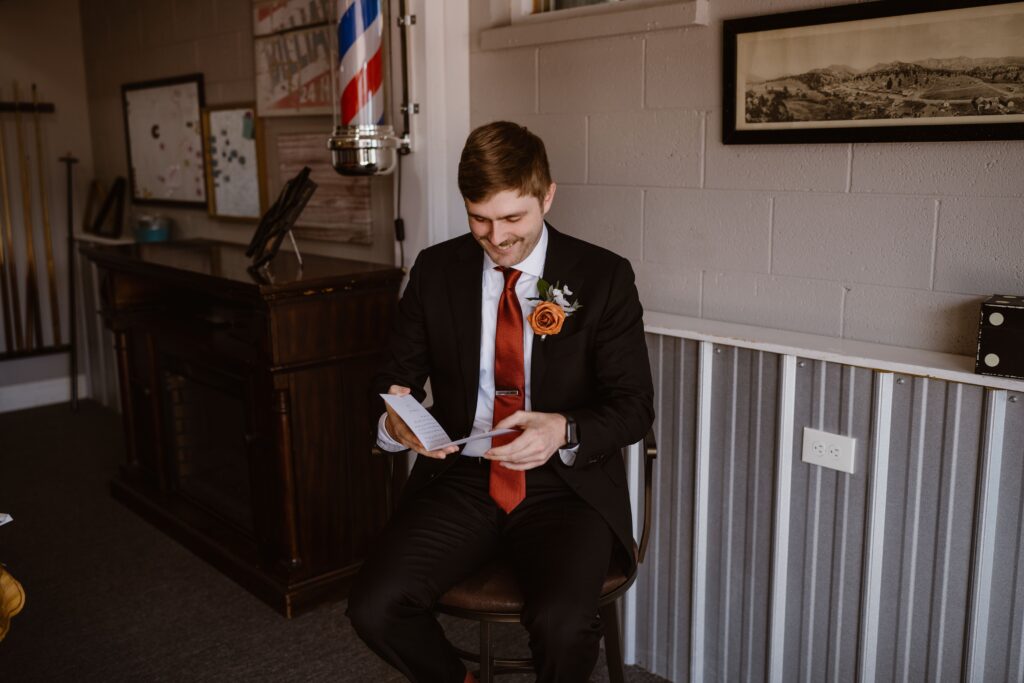 Groom reads letter from bride before their 3M Curve elopement