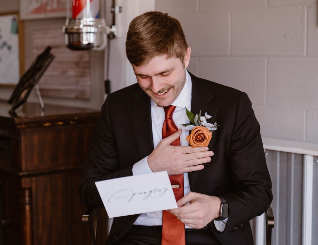 Groom reads letter from bride before their 3M Curve elopement