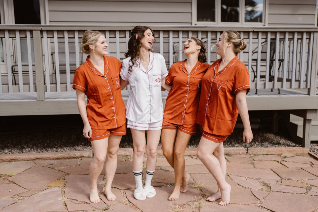 Bride laughs with her bridesmaids