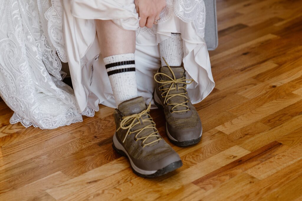 Bride puts her hiking boots on for her 3M Curve elopement in Rocky Mountain National Park