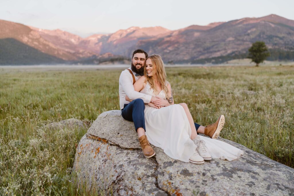 Couple takes elopement portraits at sunrise at Moraine Park in Rocky Mountain National Park in Colorado