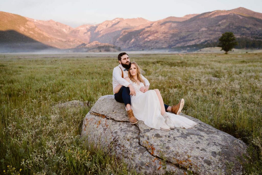 Couple takes elopement portraits at sunrise at Moraine Park in Rocky Mountain National Park in Colorado