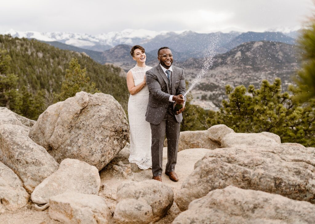 Couple celebrates after their Colorado elopement by popping champagne 