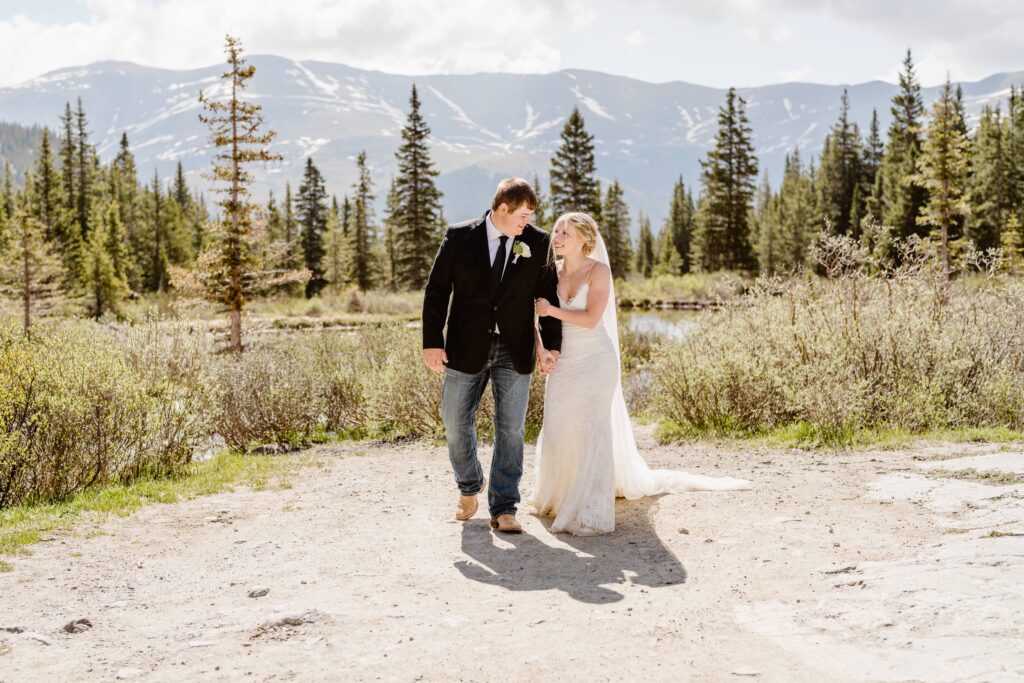 Couple walks together in the mountains after their elopement ceremony in Colorado 