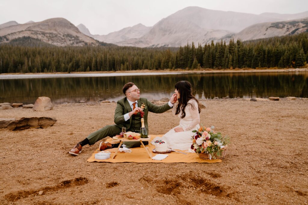 Bride and groom have a picnic before their elopement ceremony