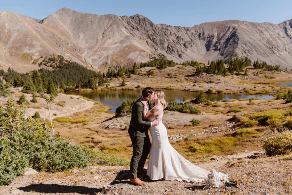 Lesbian couple shares their first kiss as wife and wife after their completely private elopement ceremony in Breckenridge, Colorado