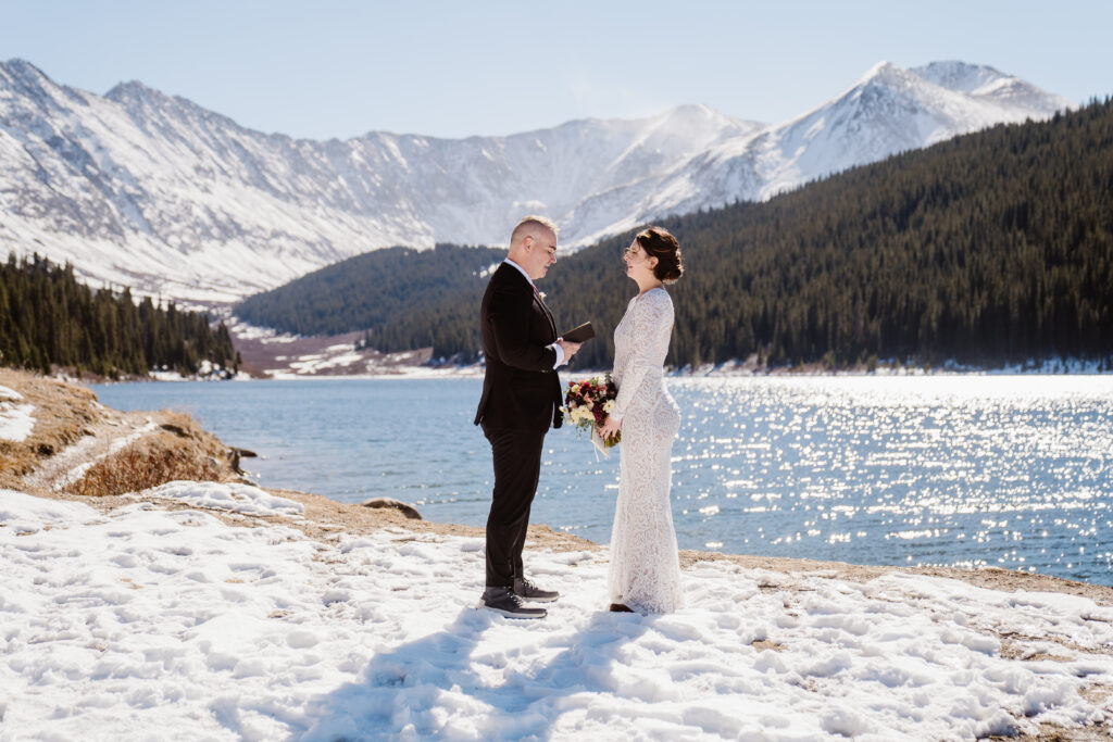 Couple exchanges vows during their Colorado elopement at the shore of an alpine lake