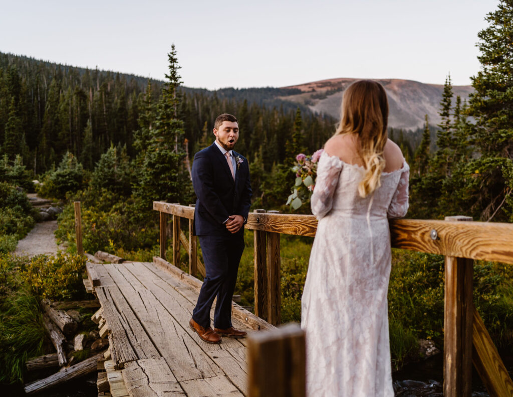 Couple having a first look during their mountain wedding