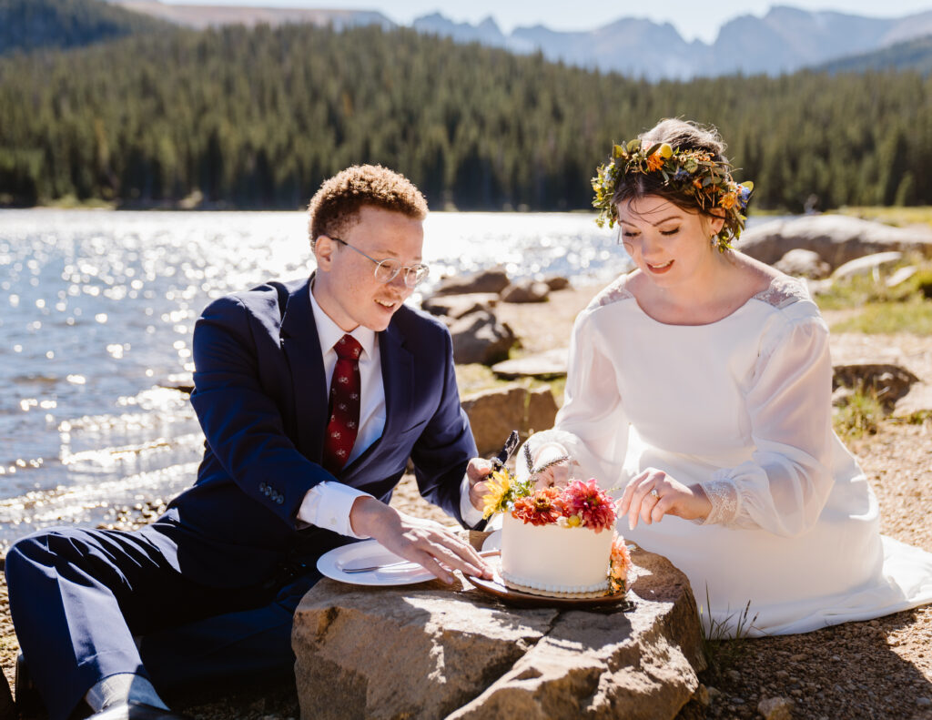 Couple has a cake after their wedding in the Colorado mountains