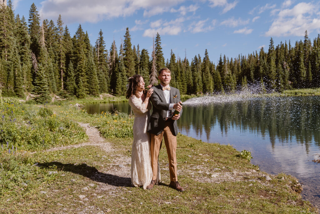Couple sprays champagne after their wedding in Telluride, Colorado