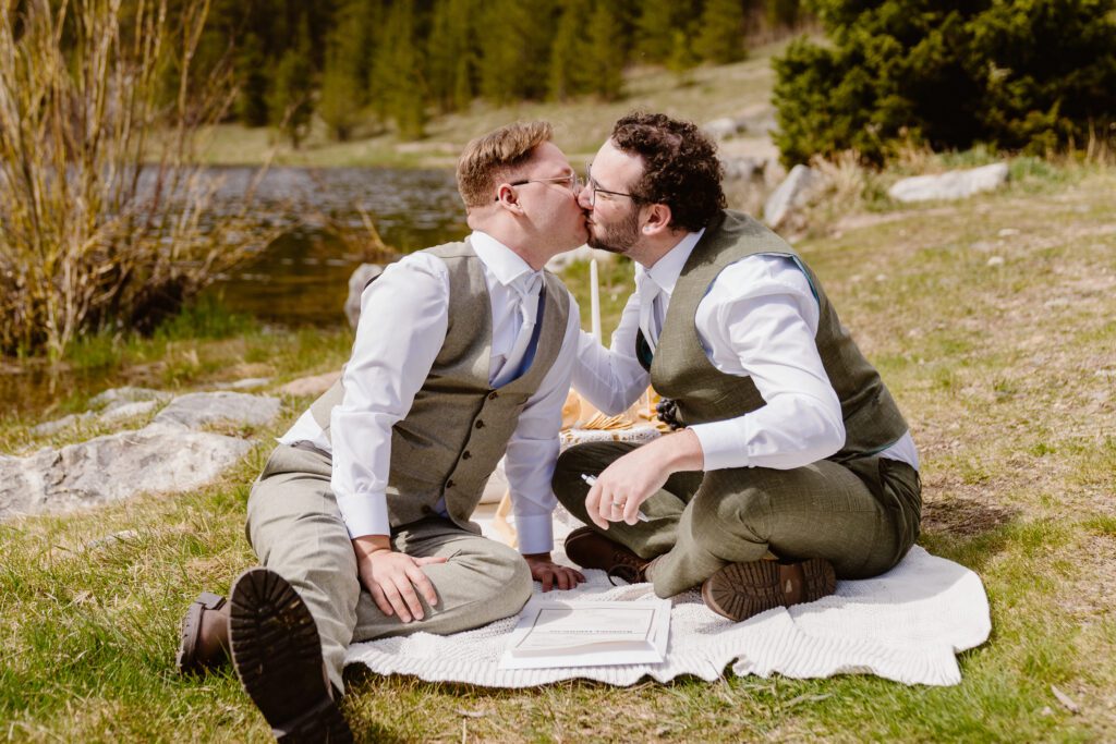 couple kisses after they sign their colorado marriage license after their elopement