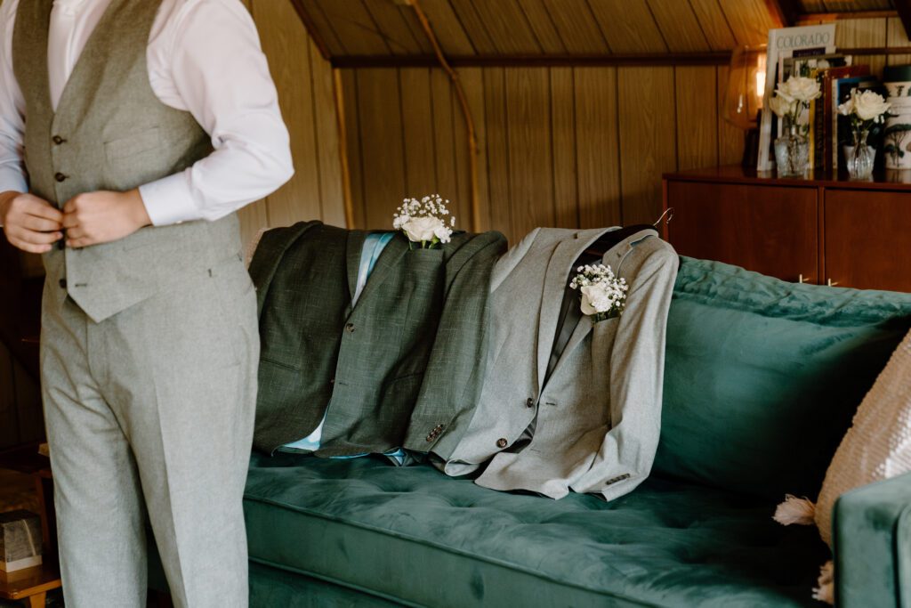 couple gets ready for their wedding at an a frame cabin