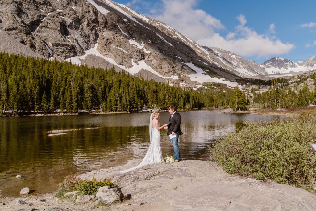 couple exchanges vows in the mountains during their colorado wedding