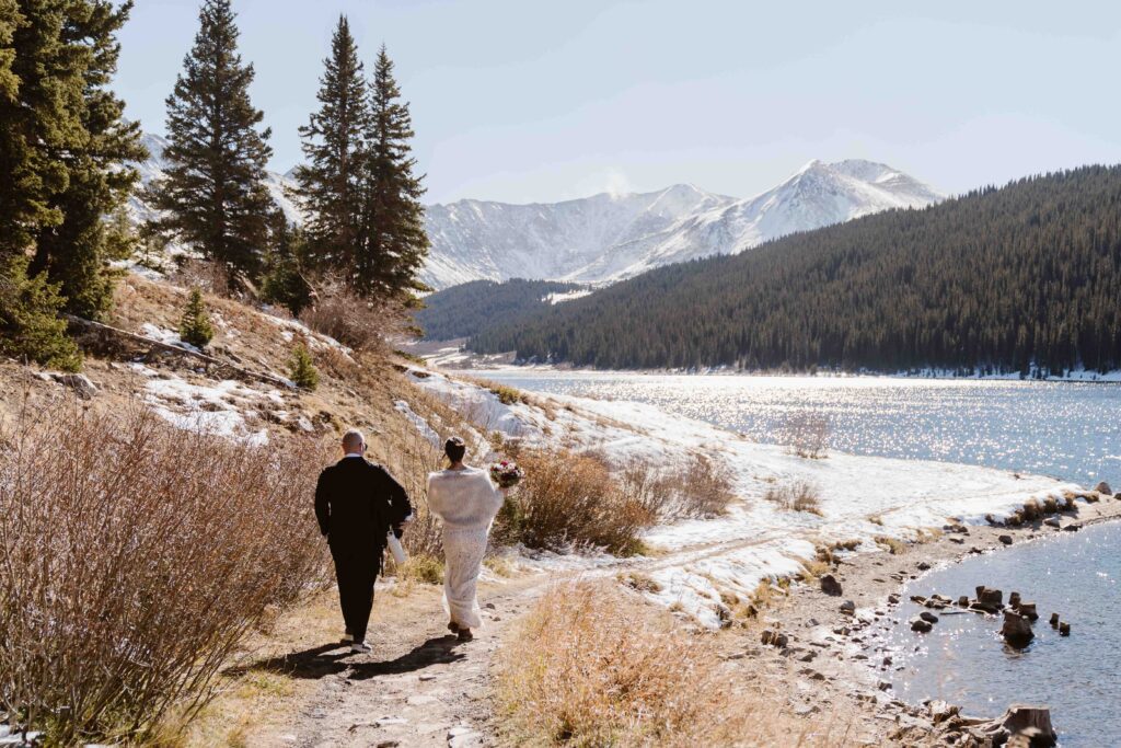 Couple walking to their ceremony site for their Breckenridge, Colorado winter elopement