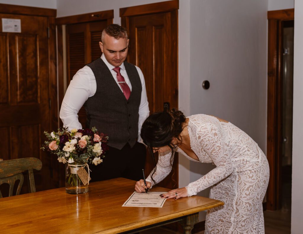 Bride Signs Marriage License During Breckenridge Elopement