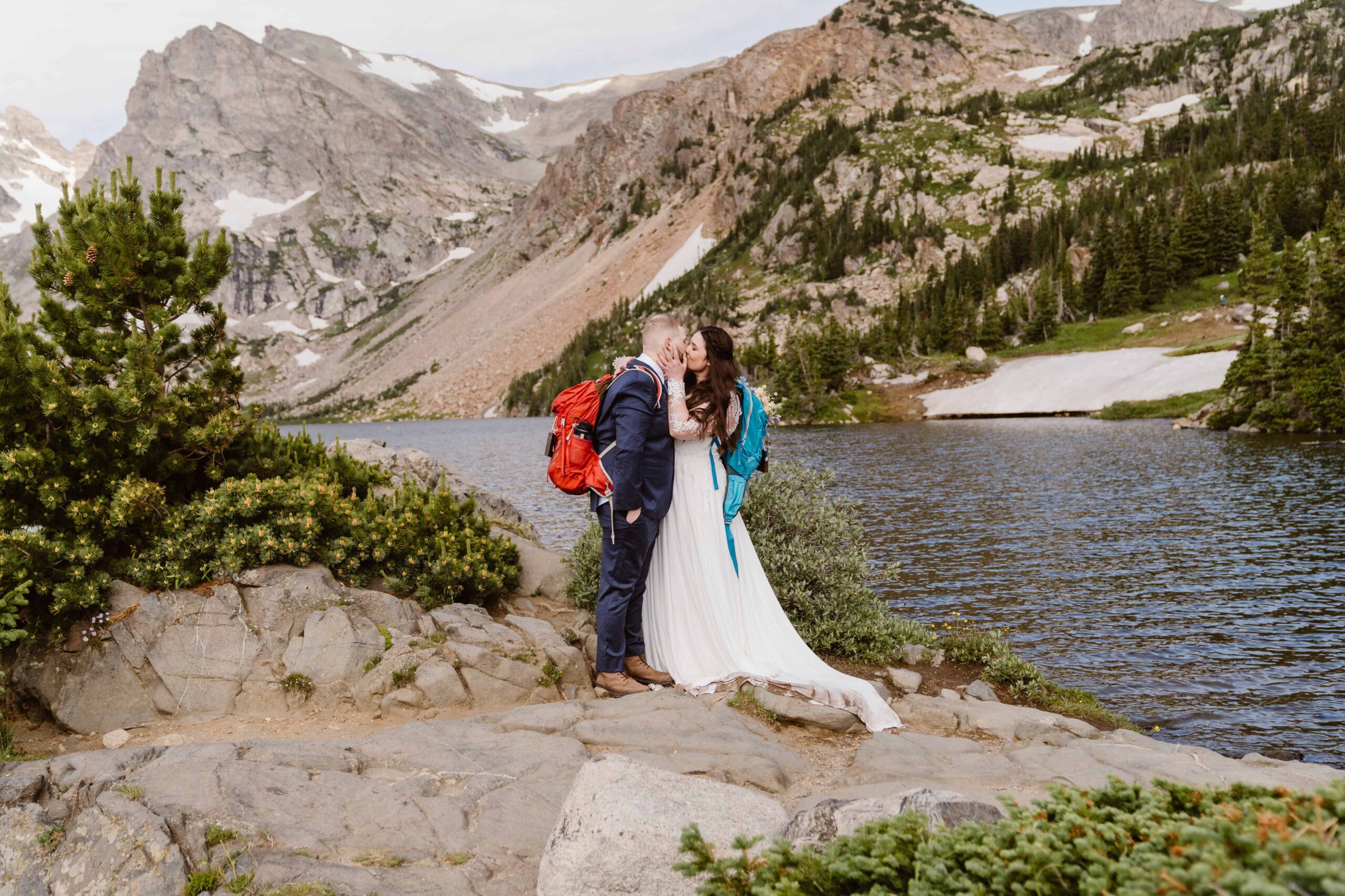 couple kisses with backpacks on after their lake isabelle, colorado elopement