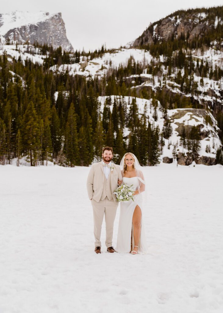 Portraits of bride and groom on Bear Lake in Rocky Mountain National Park in the winter