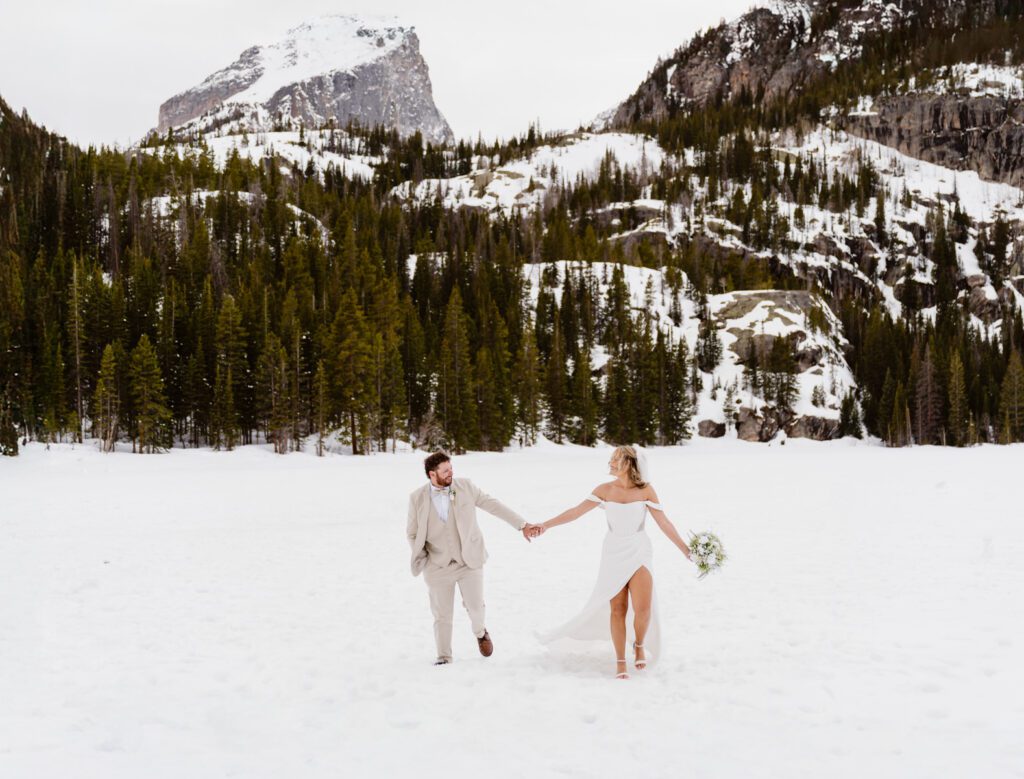 Portraits of bride and groom on Bear Lake in Rocky Mountain National Park in the winter