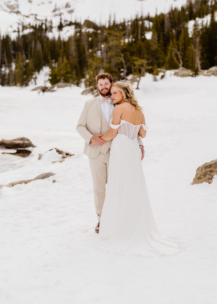 Bride and groom portraits at Dream Lake in Rocky Mountain National Park in the winter time