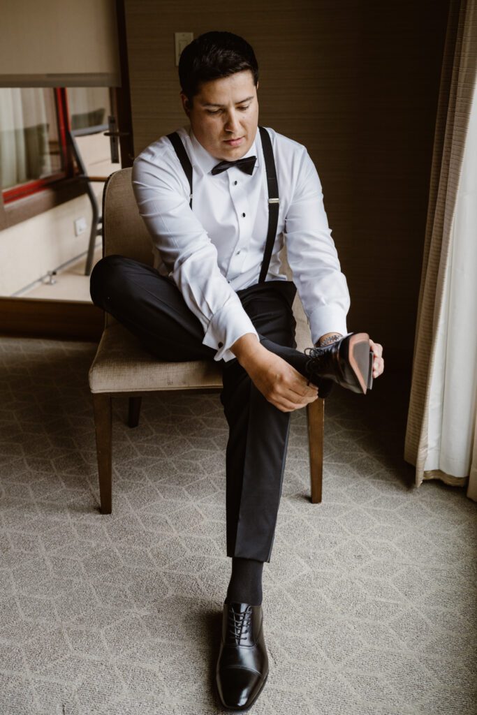 Groom getting ready at the Viceroy in Aspen, Colorado for her wedding in Aspen.