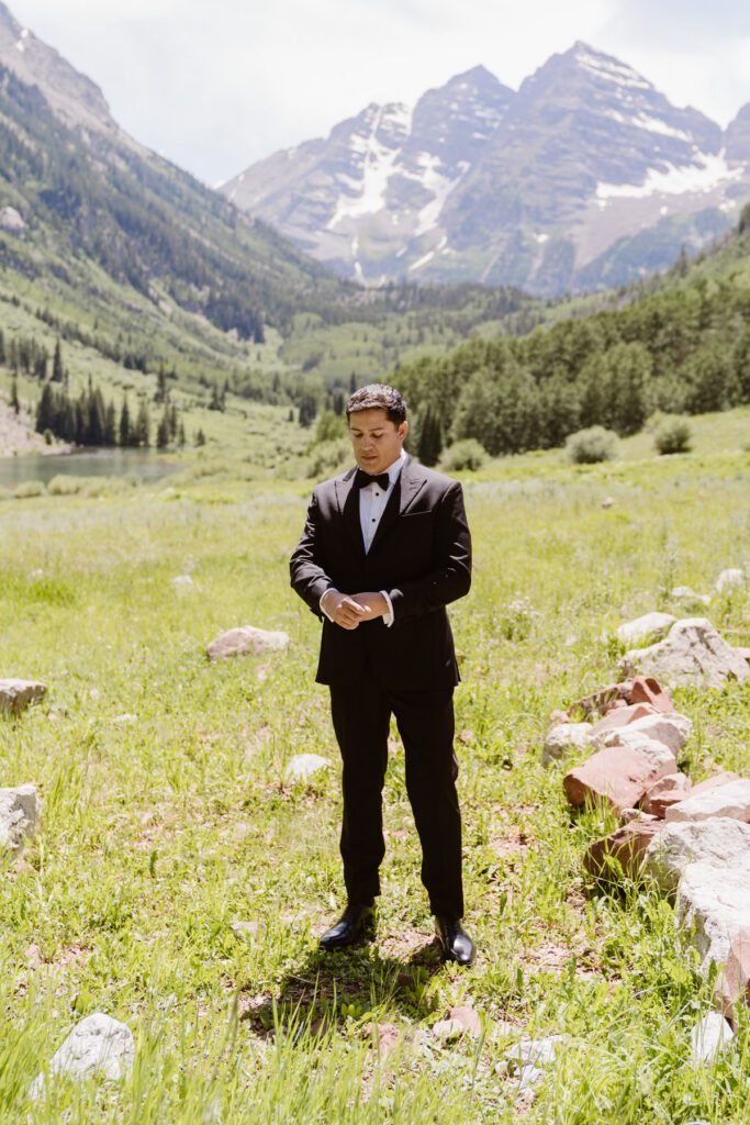 Wedding portraits of a bride and groom in the summertime at the Maroon Bells Amphitheater in Aspen, Colorado