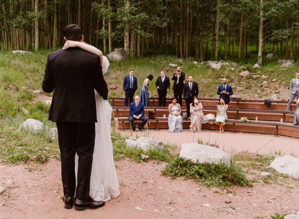 Wedding portraits of a bride and groom in the summertime at the Maroon Bells Amphitheater in Aspen, Colorado