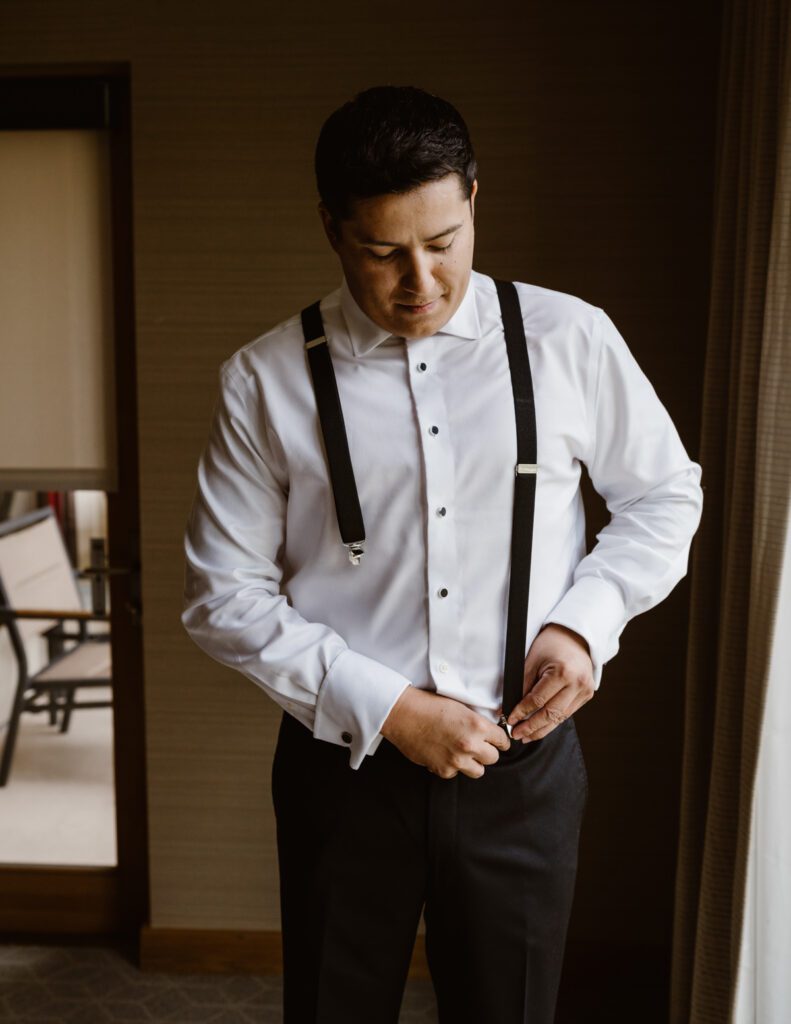 Groom getting ready at the Viceroy in Aspen, Colorado for her wedding in Aspen.