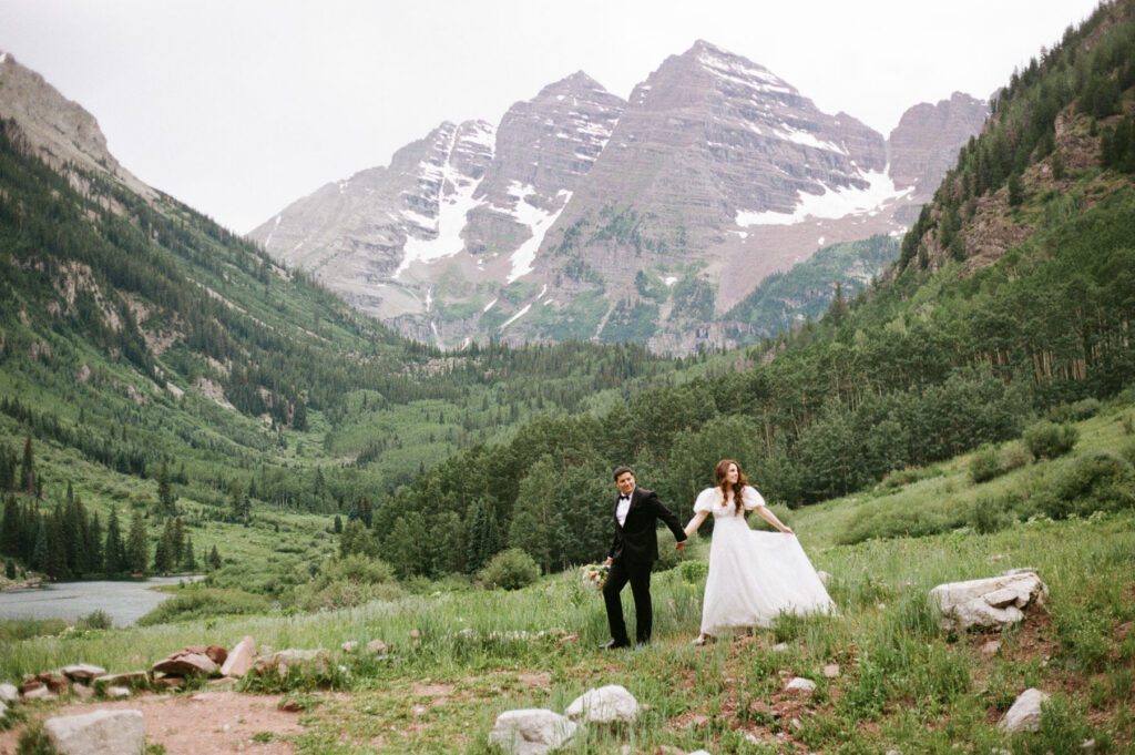 Film wedding portraits of a bride and groom in the summertime at the Maroon Bells Amphitheater in Aspen, Colorado
