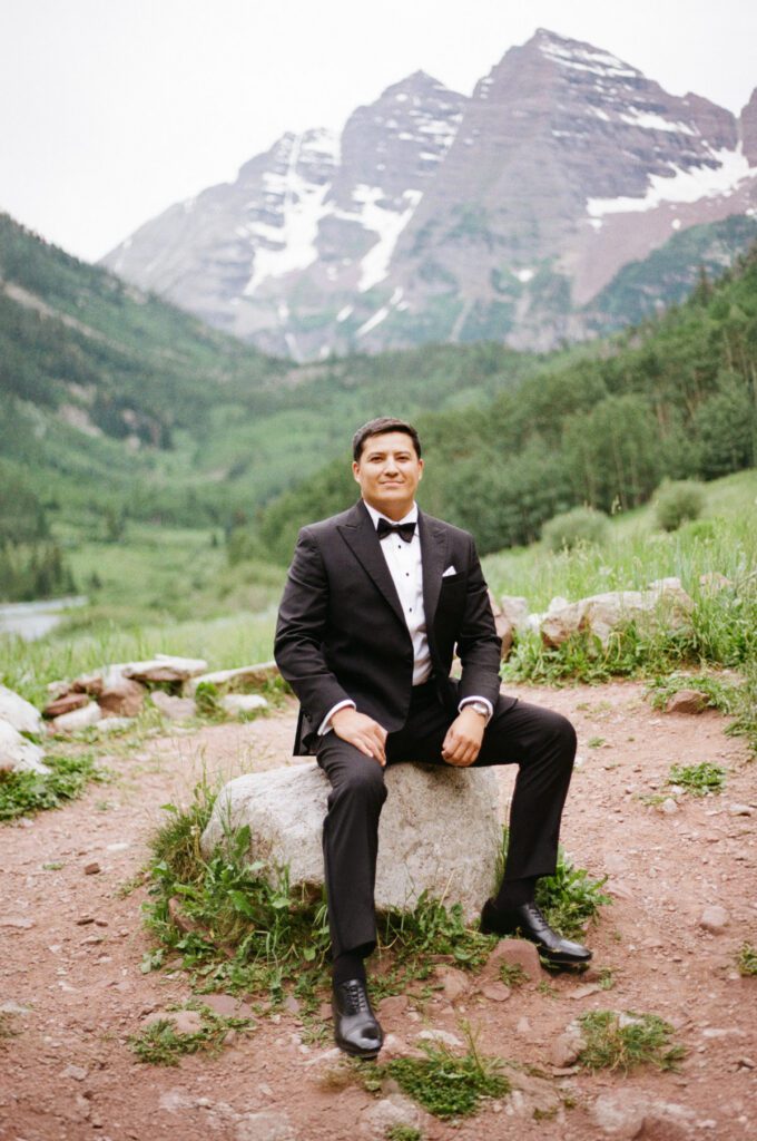 Film wedding portraits of a bride and groom in the summertime at the Maroon Bells Amphitheater in Aspen, Colorado