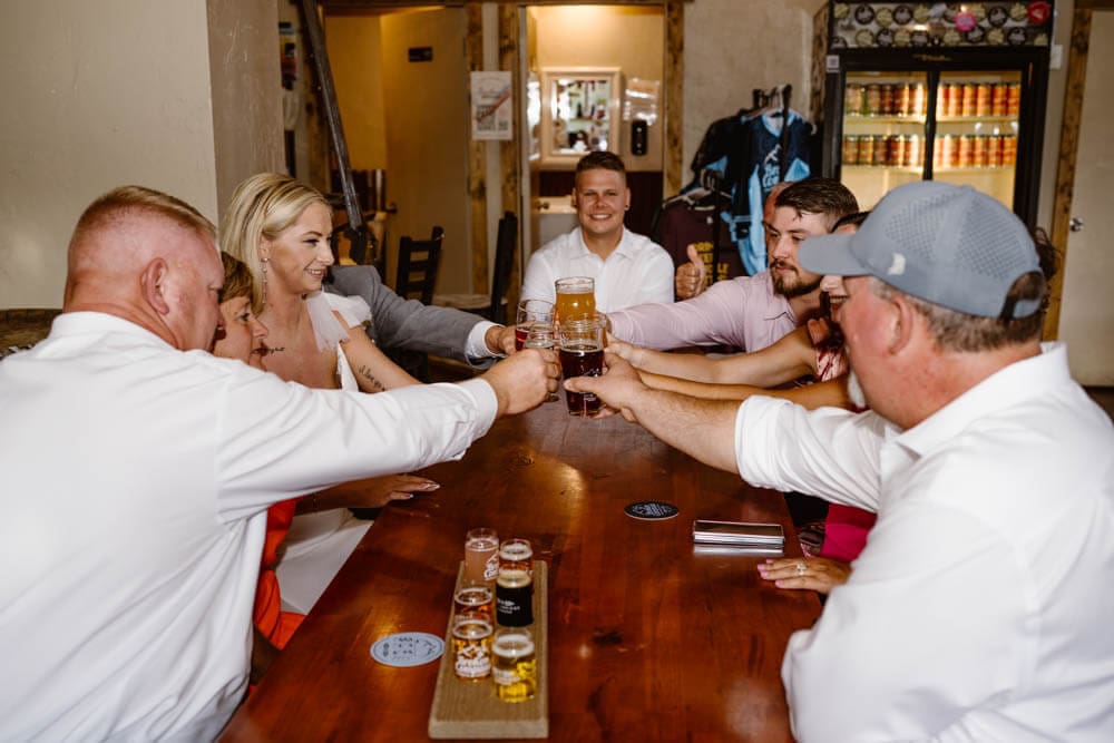 Family toasts to the bride and groom at a brewery in Breckenridge Colorado after their wedding